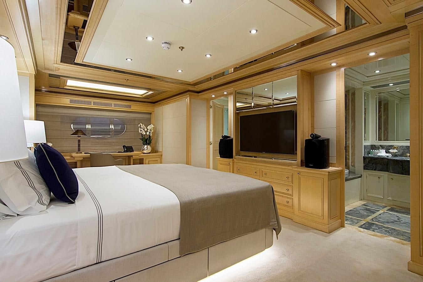 a hotel room with a bed and tv aboard INVADER Yacht for Sale