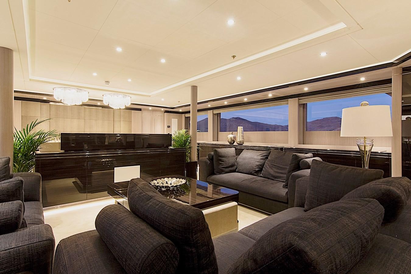a living room with a piano and a large window aboard INVADER Yacht for Sale