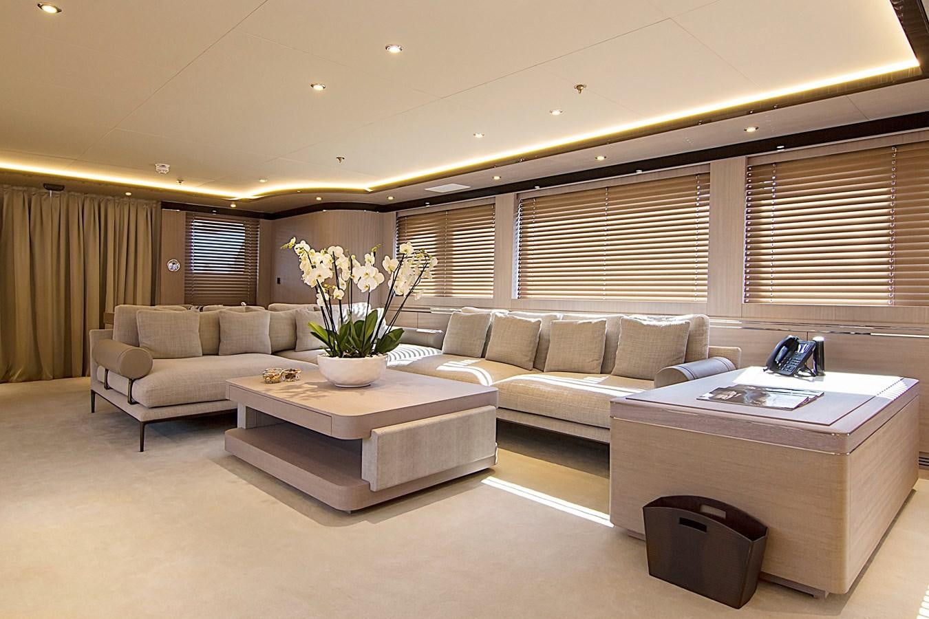 a living room with a couch and a coffee table aboard INVADER Yacht for Sale