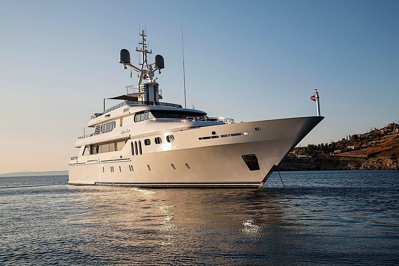 a large white ship in the water aboard INVADER Yacht for Sale