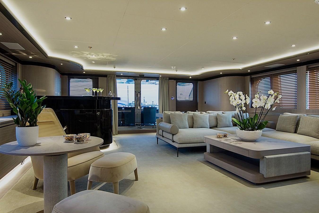 a living room with a piano and a table aboard INVADER Yacht for Sale