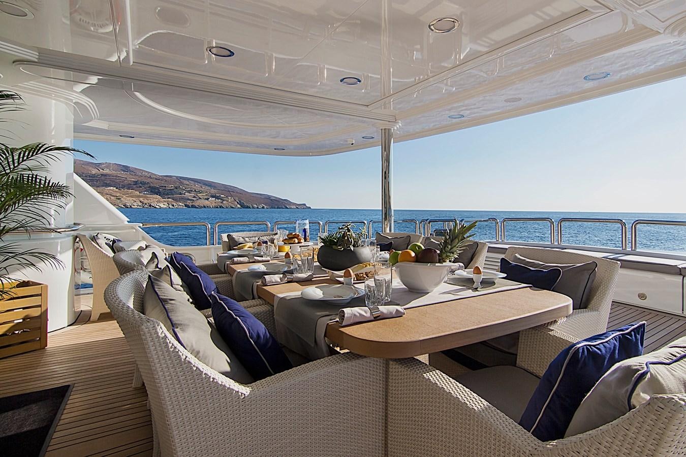a room with a table and chairs aboard INVADER Yacht for Sale