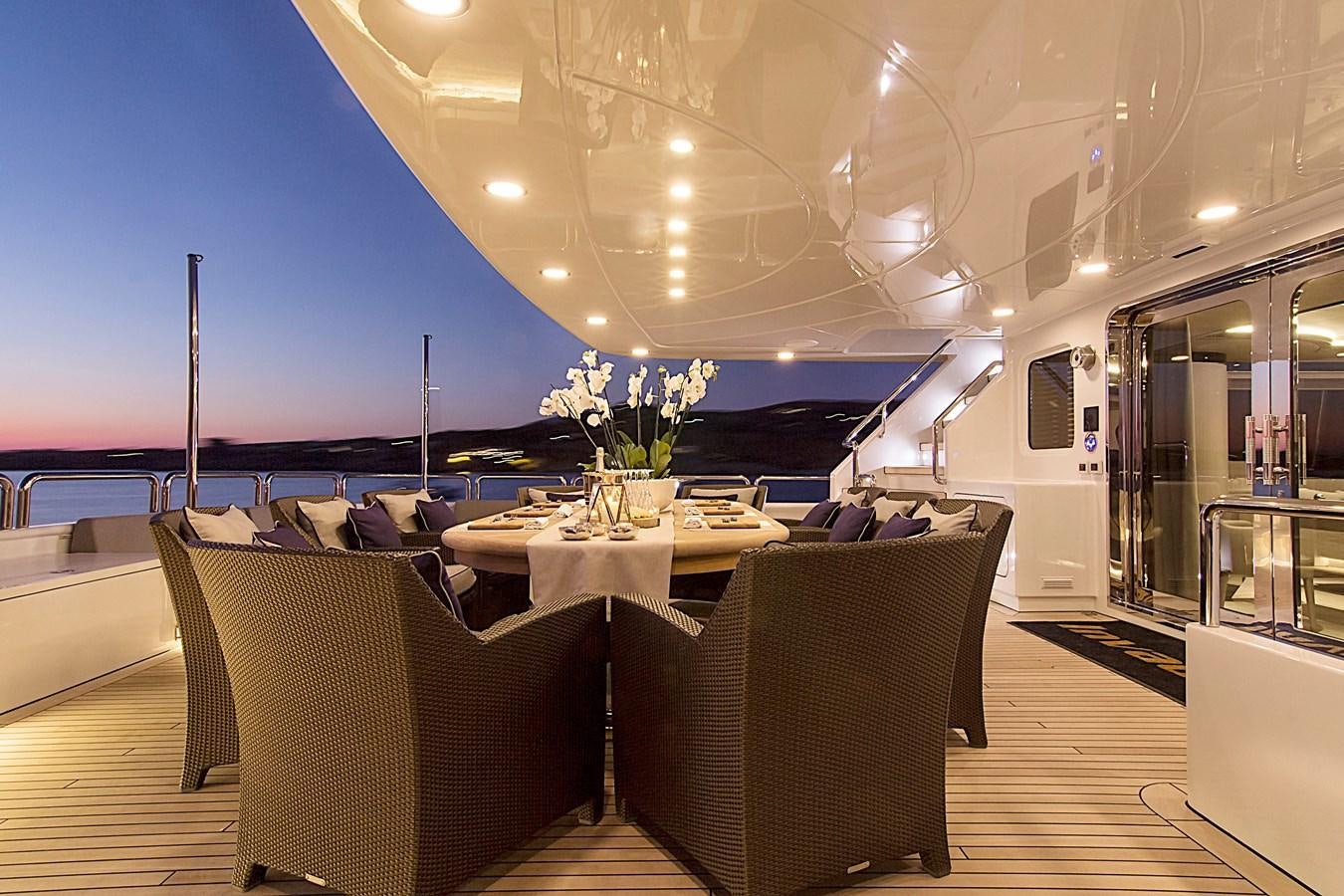 a room with a table and chairs aboard INVADER Yacht for Sale