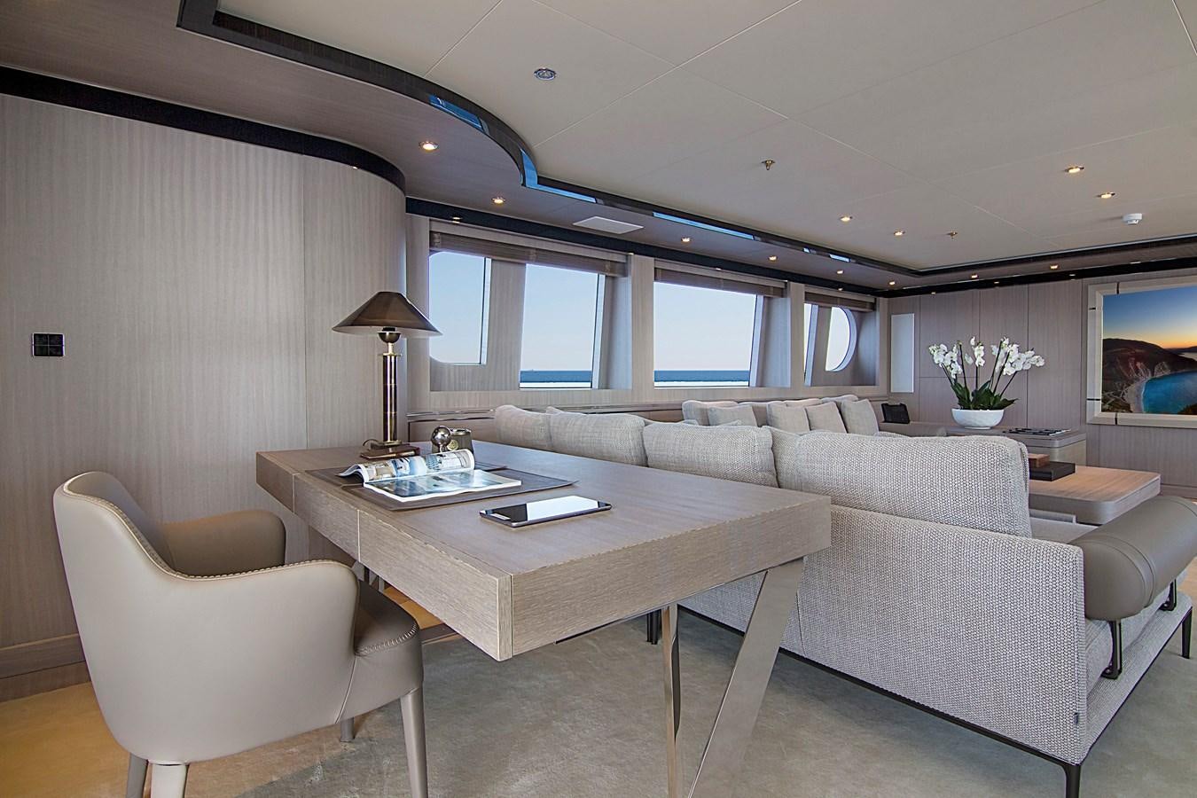 a living room with a couch and a table aboard INVADER Yacht for Sale