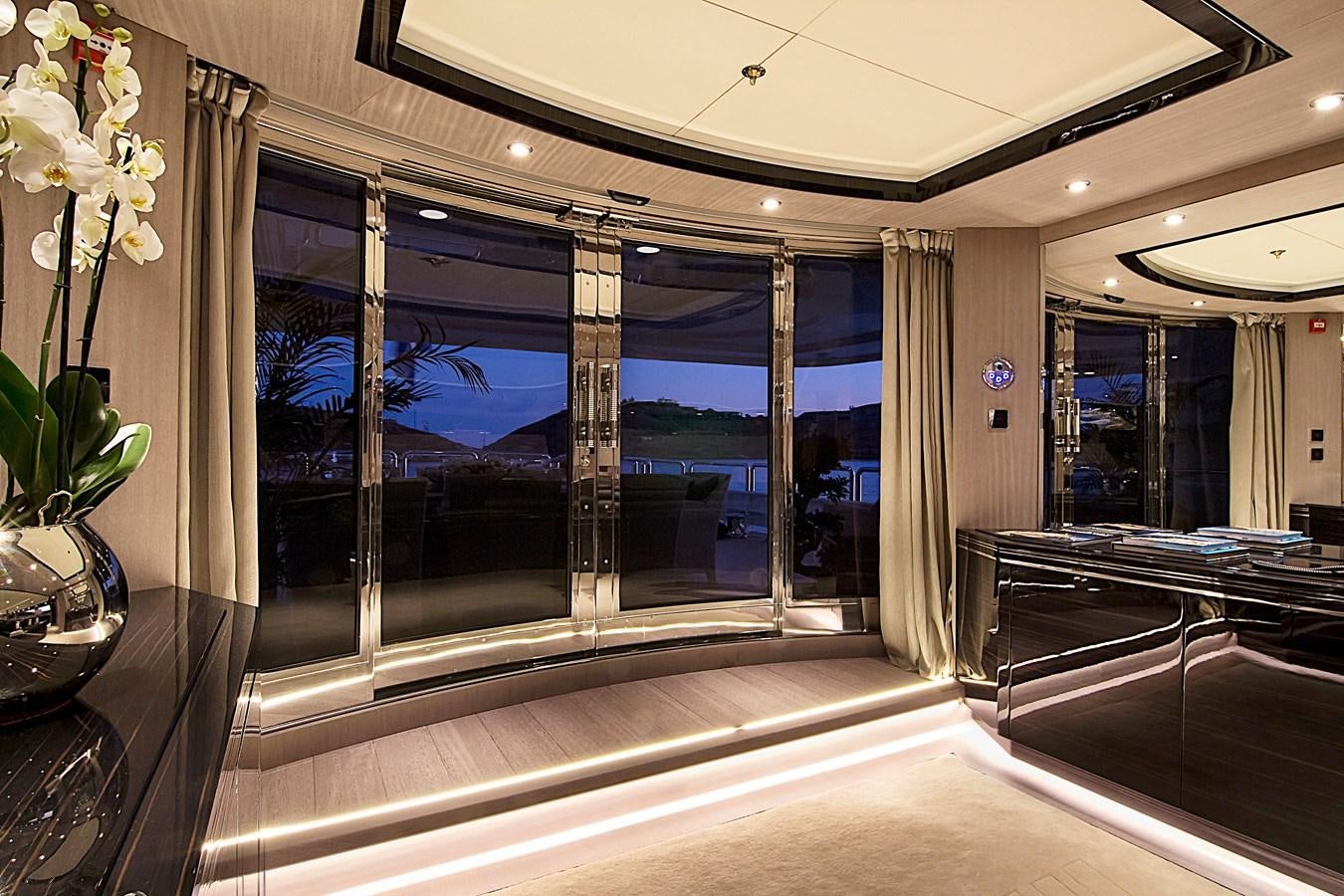 a large glass walled room with a large window and flowers aboard INVADER Yacht for Sale