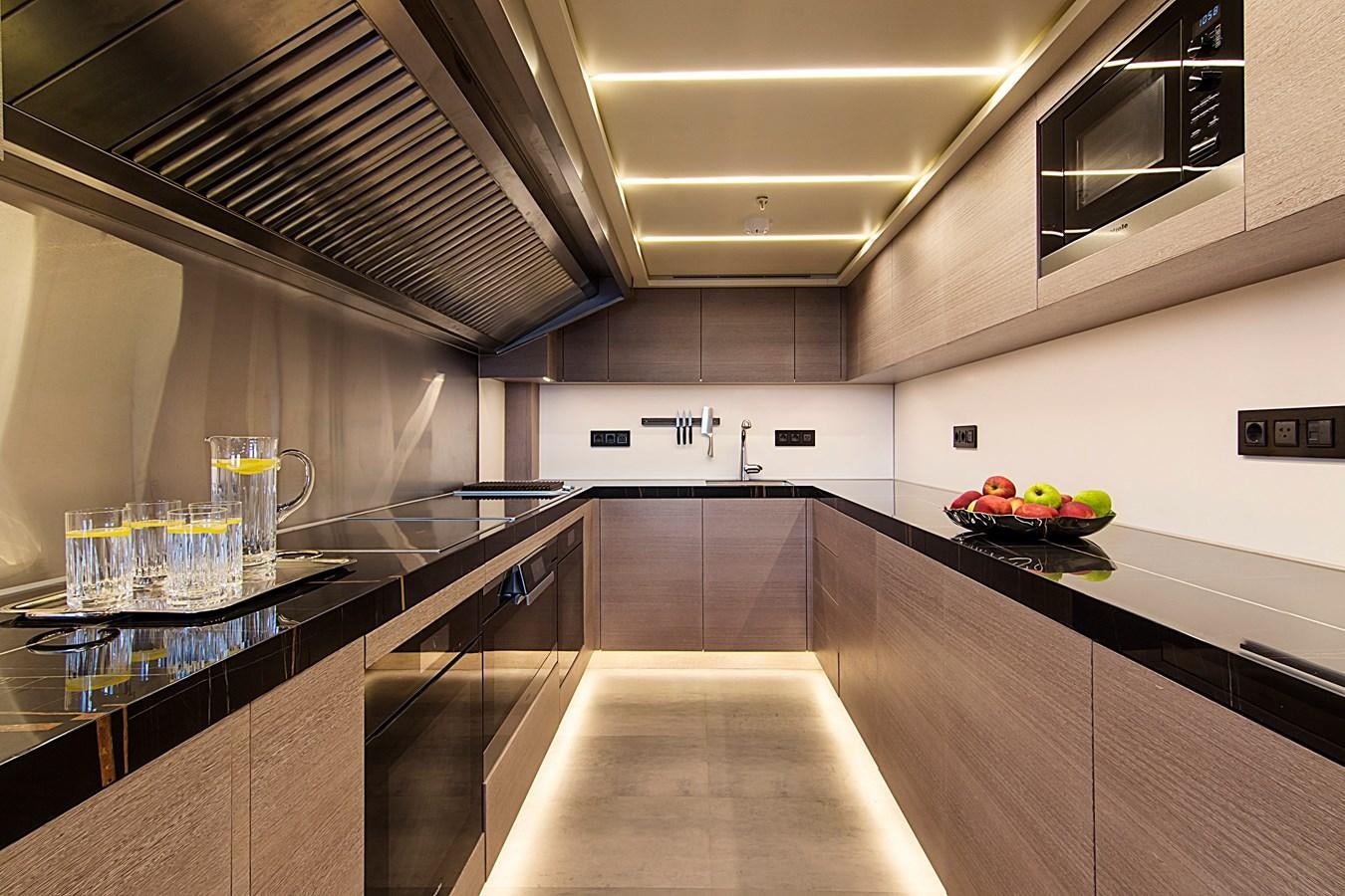 a kitchen with a large island aboard INVADER Yacht for Sale