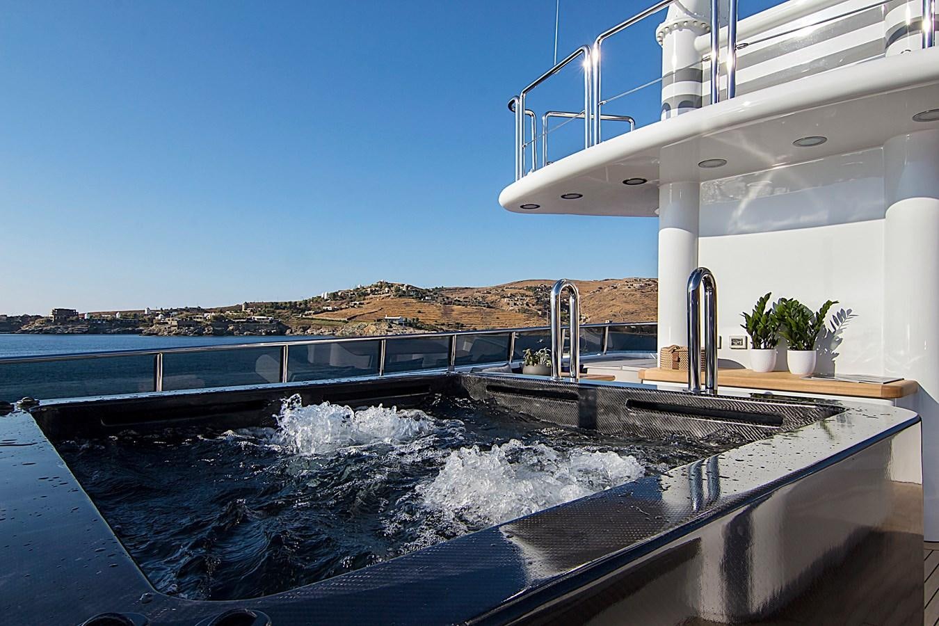 a large pool of water aboard INVADER Yacht for Sale