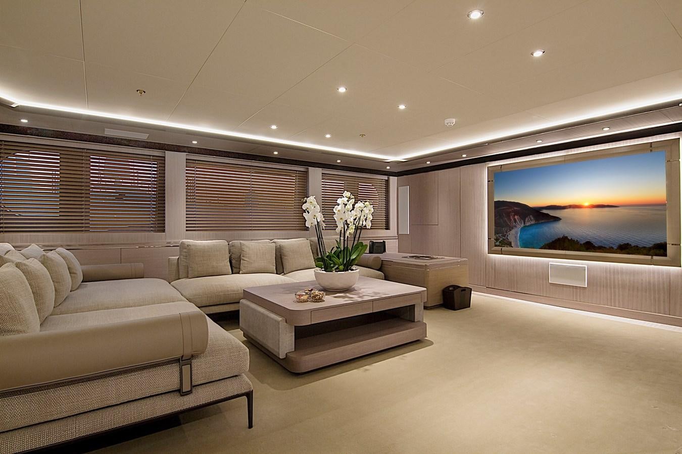 a living room with a large screen aboard INVADER Yacht for Sale