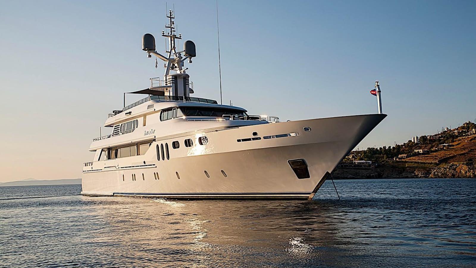 a large white ship in the water aboard INVADER Yacht for Sale