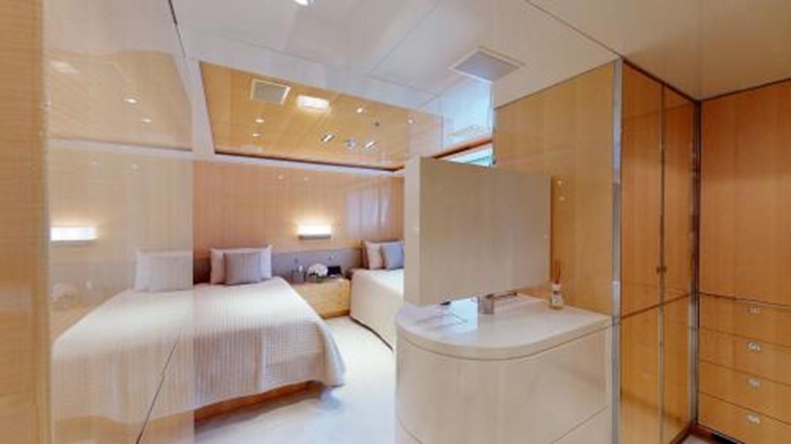 a room with a bed and a table aboard LA PELLEGRINA 1 Yacht for Sale