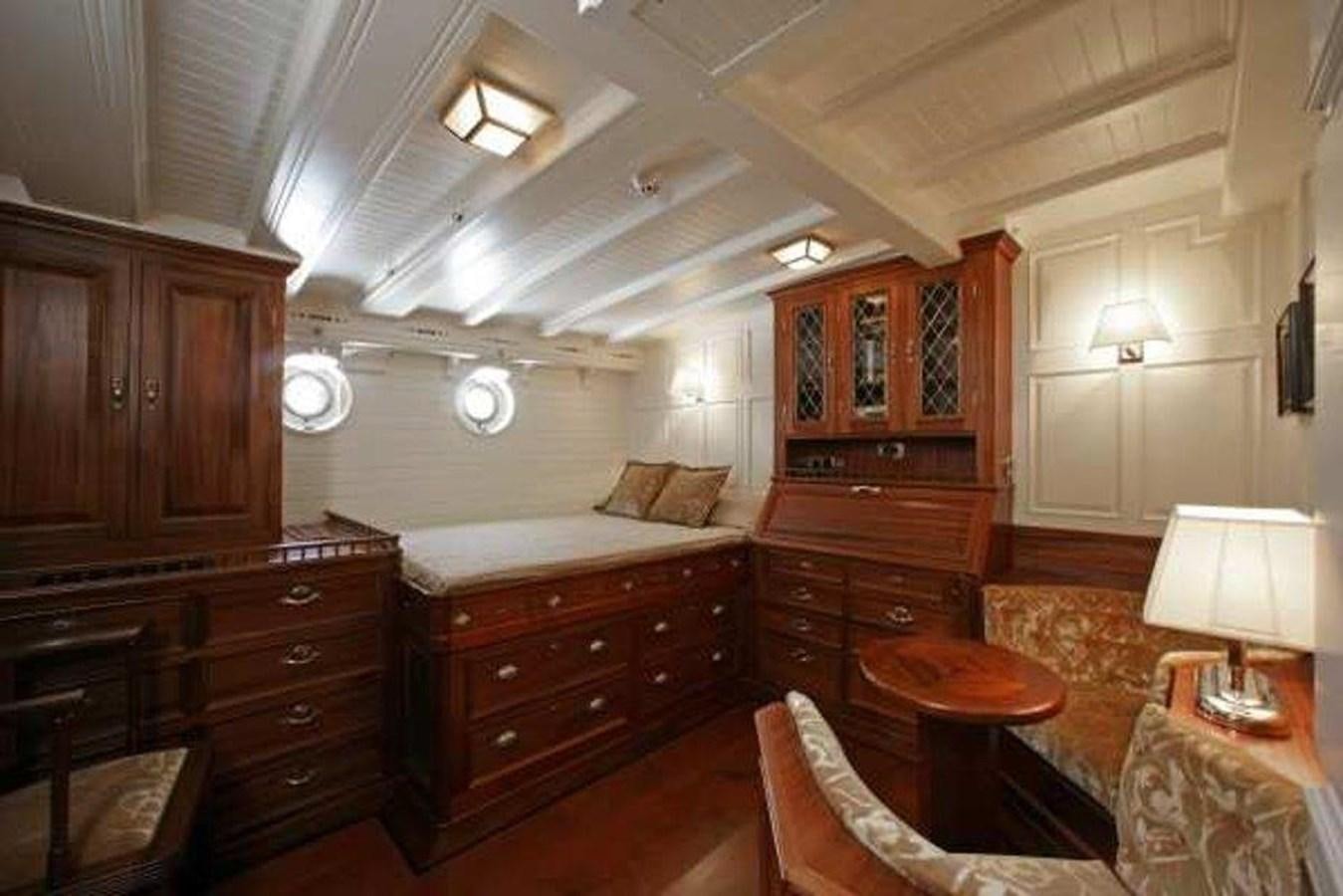 a bedroom with a bed and a table aboard ELEONORA Yacht for Sale