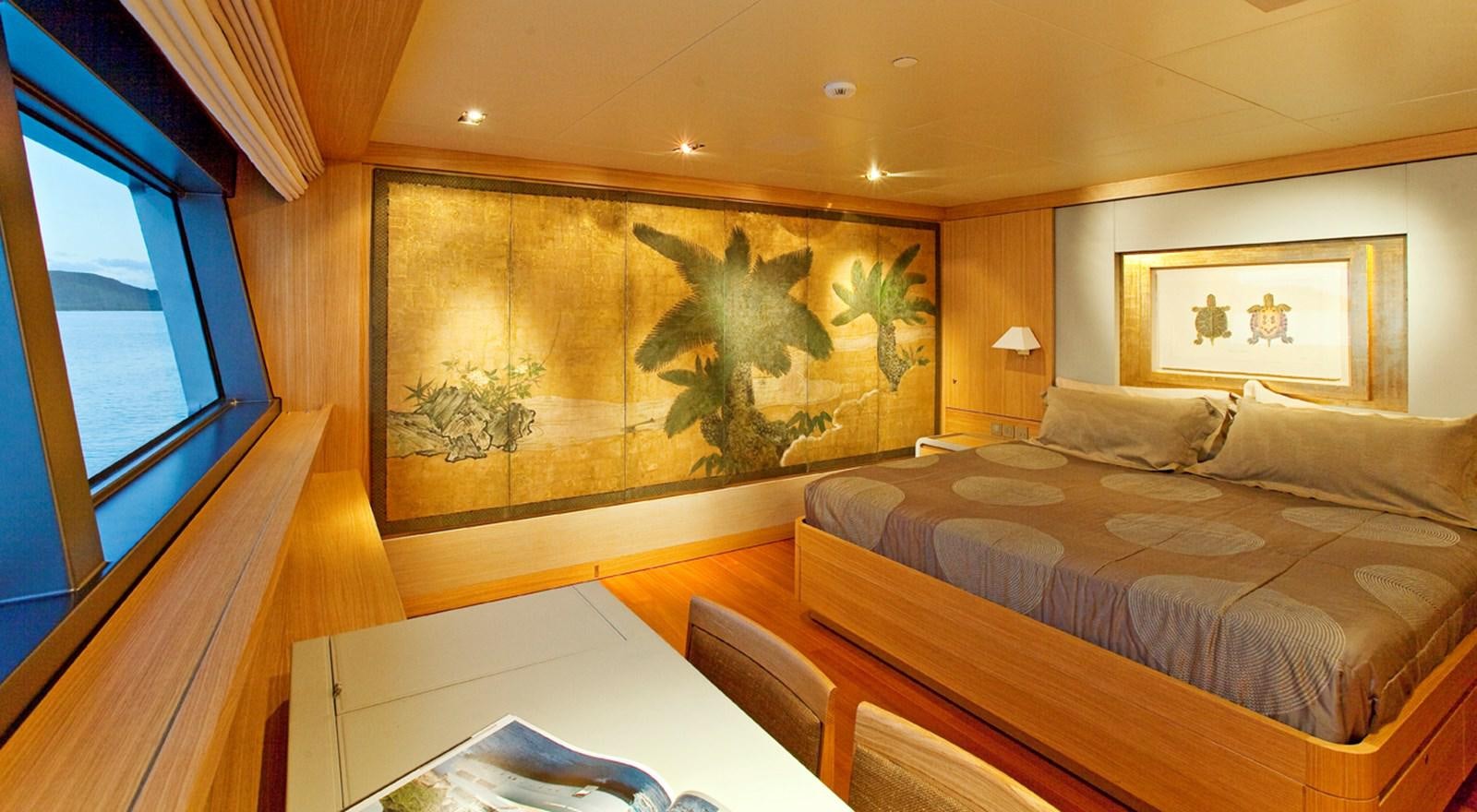 a room with a bed and a painting on the wall aboard FALCO MOSCATA Yacht for Sale