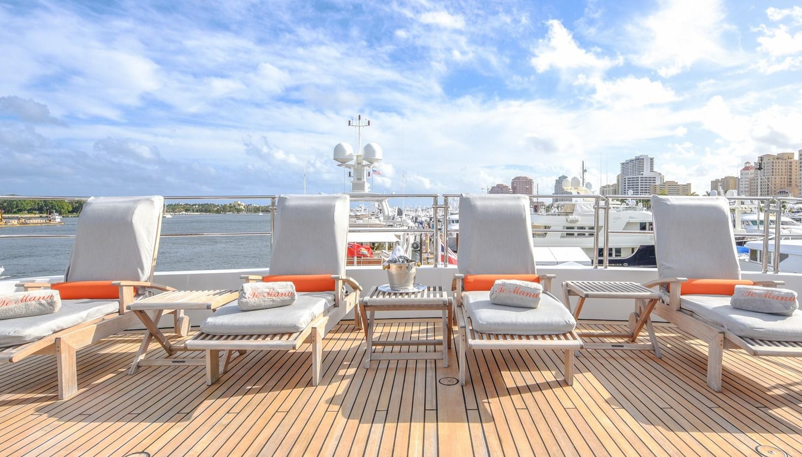 a deck with chairs and tables aboard TE MANU Yacht for Sale