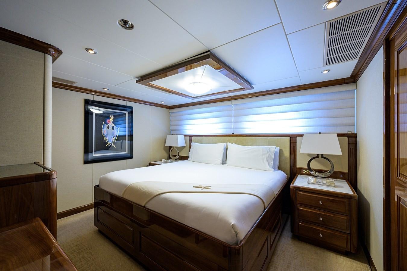 a bedroom with a bed and a lamp aboard REMEMBER WHEN Yacht for Charter