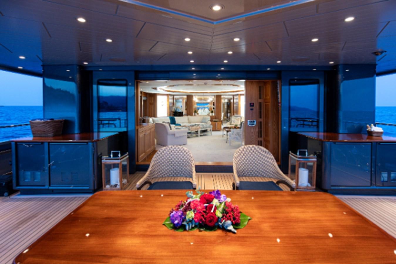 a large room with a table and chairs aboard VIBRANCE Yacht for Sale