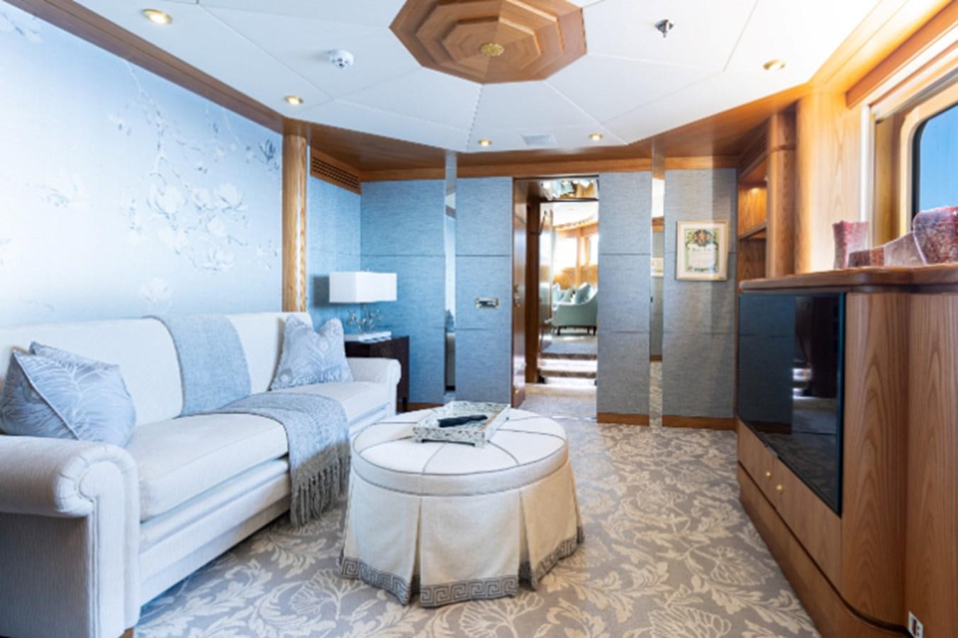 a living room with a couch and a television aboard VIBRANCE Yacht for Sale