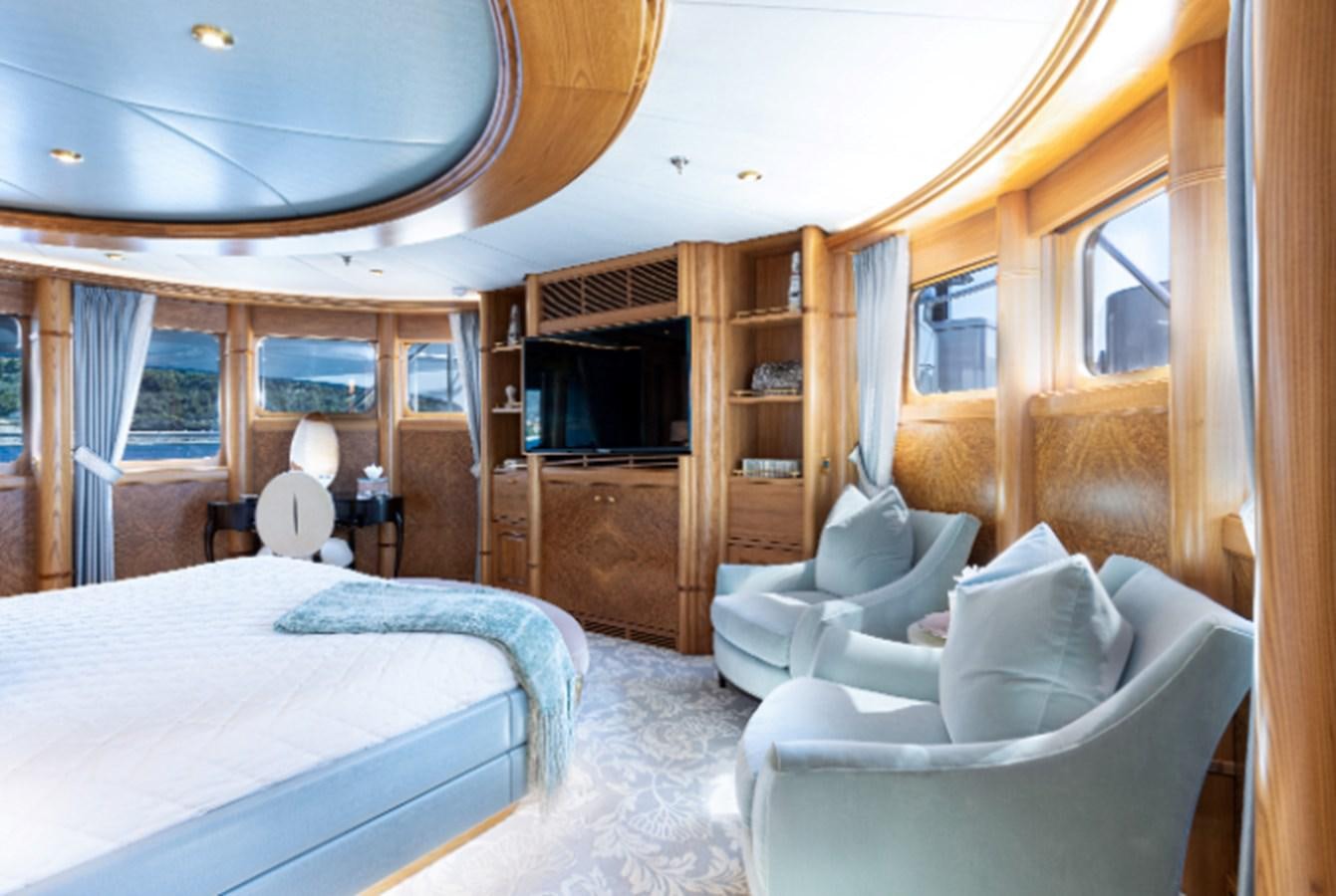 a bedroom with a bed and a tv aboard VIBRANCE Yacht for Sale