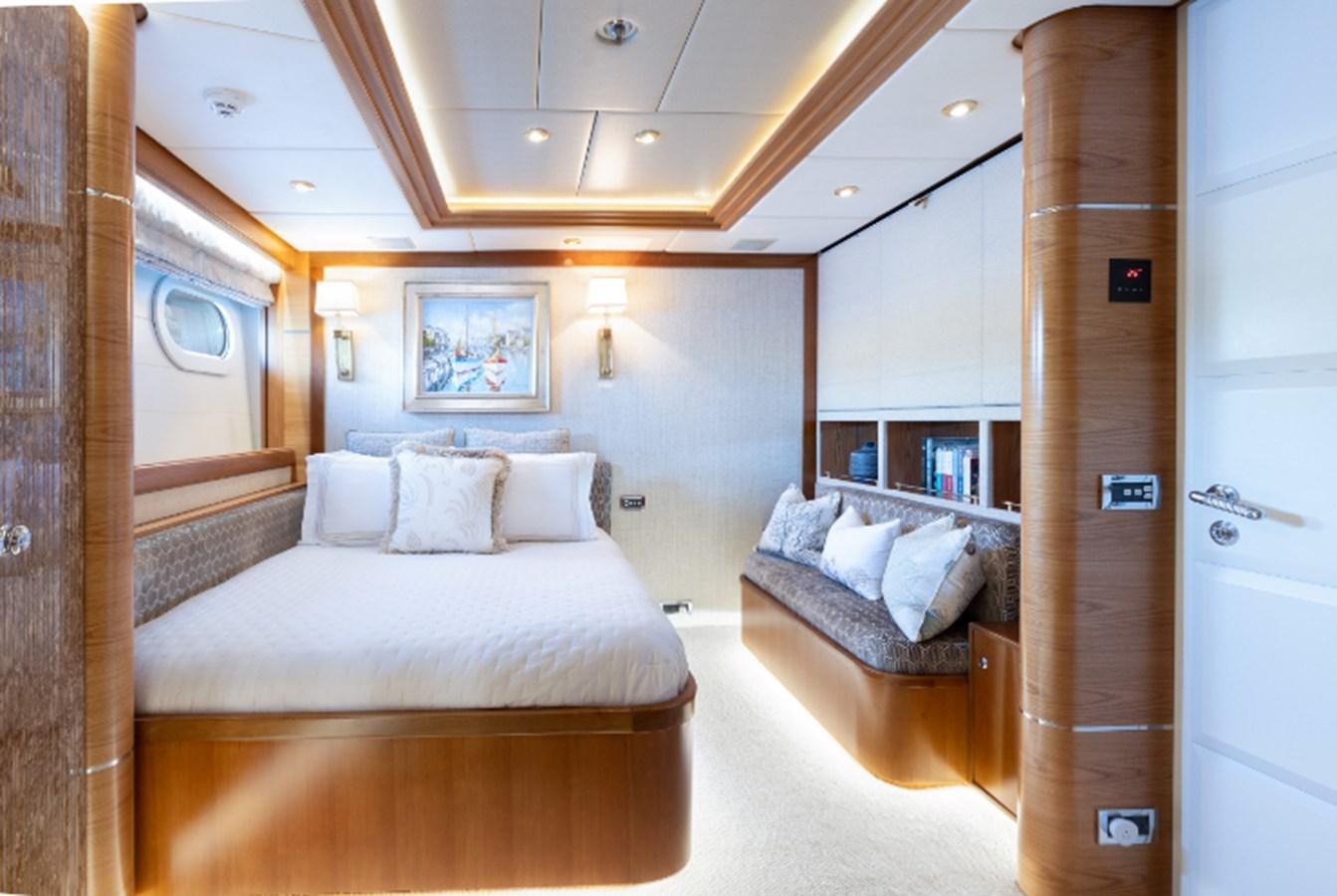 a room with a bed and a mirror aboard VIBRANCE Yacht for Sale