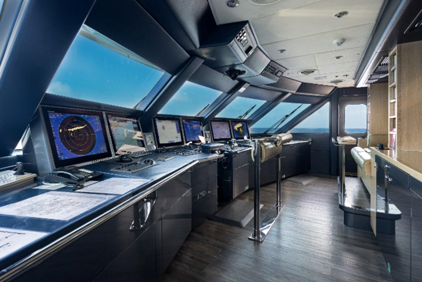 a room with many monitors and computers aboard VIBRANCE Yacht for Sale
