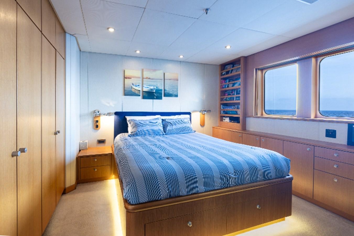 a bedroom with a bed aboard VIBRANCE Yacht for Sale
