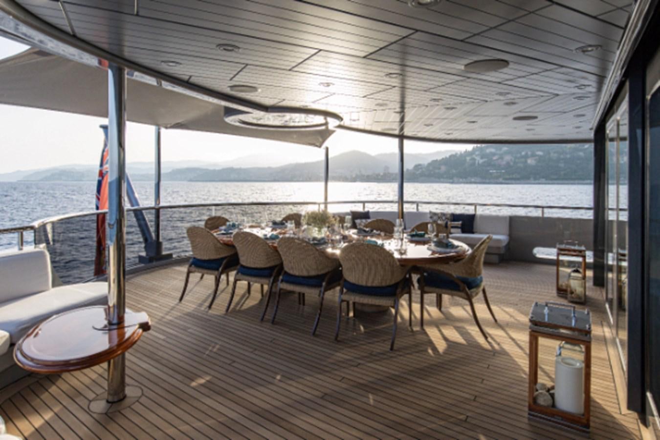 a table and chairs on a deck aboard VIBRANCE Yacht for Sale