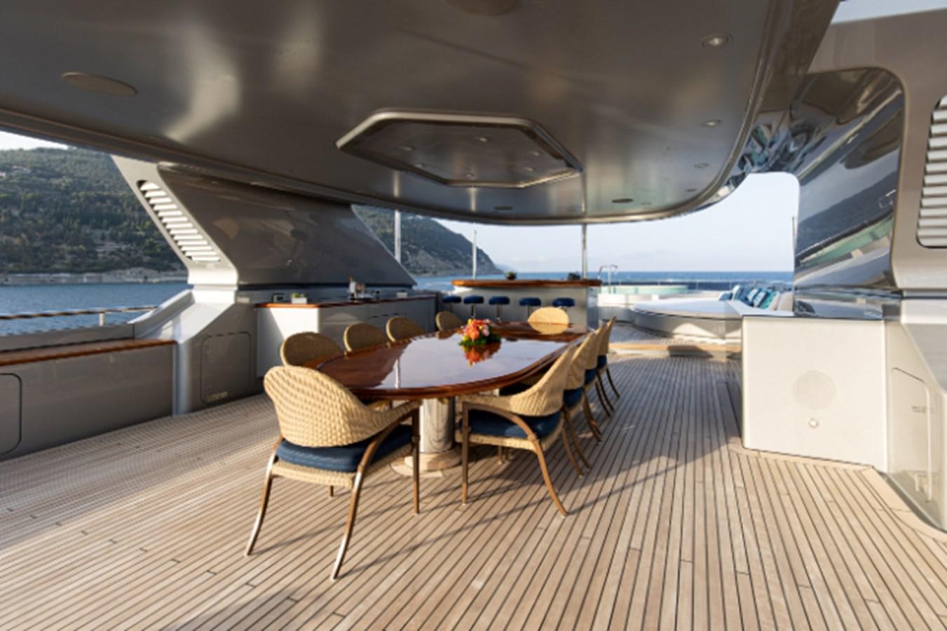 a table and chairs on a deck aboard VIBRANCE Yacht for Sale