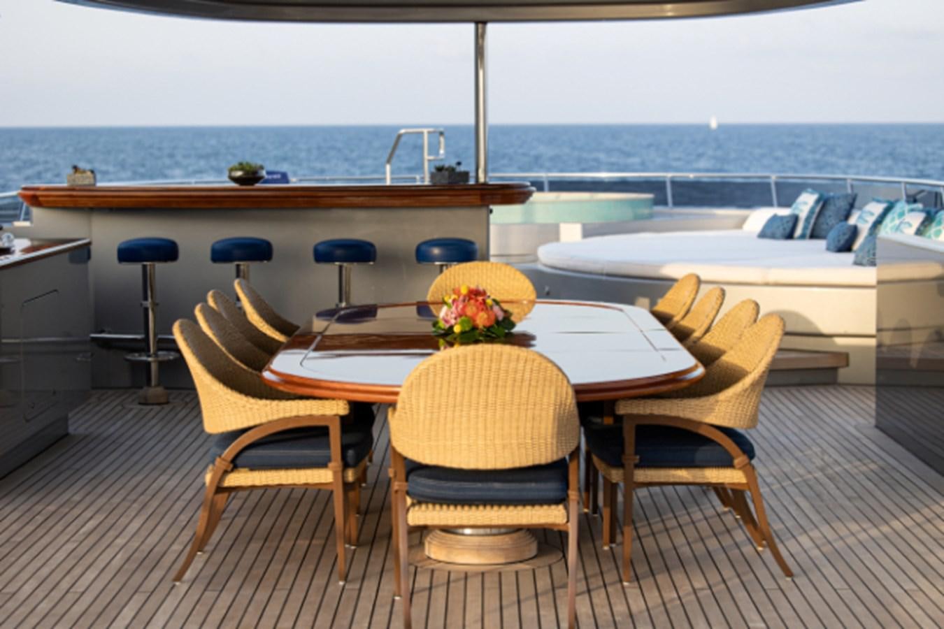 a table and chairs on a deck aboard VIBRANCE Yacht for Sale
