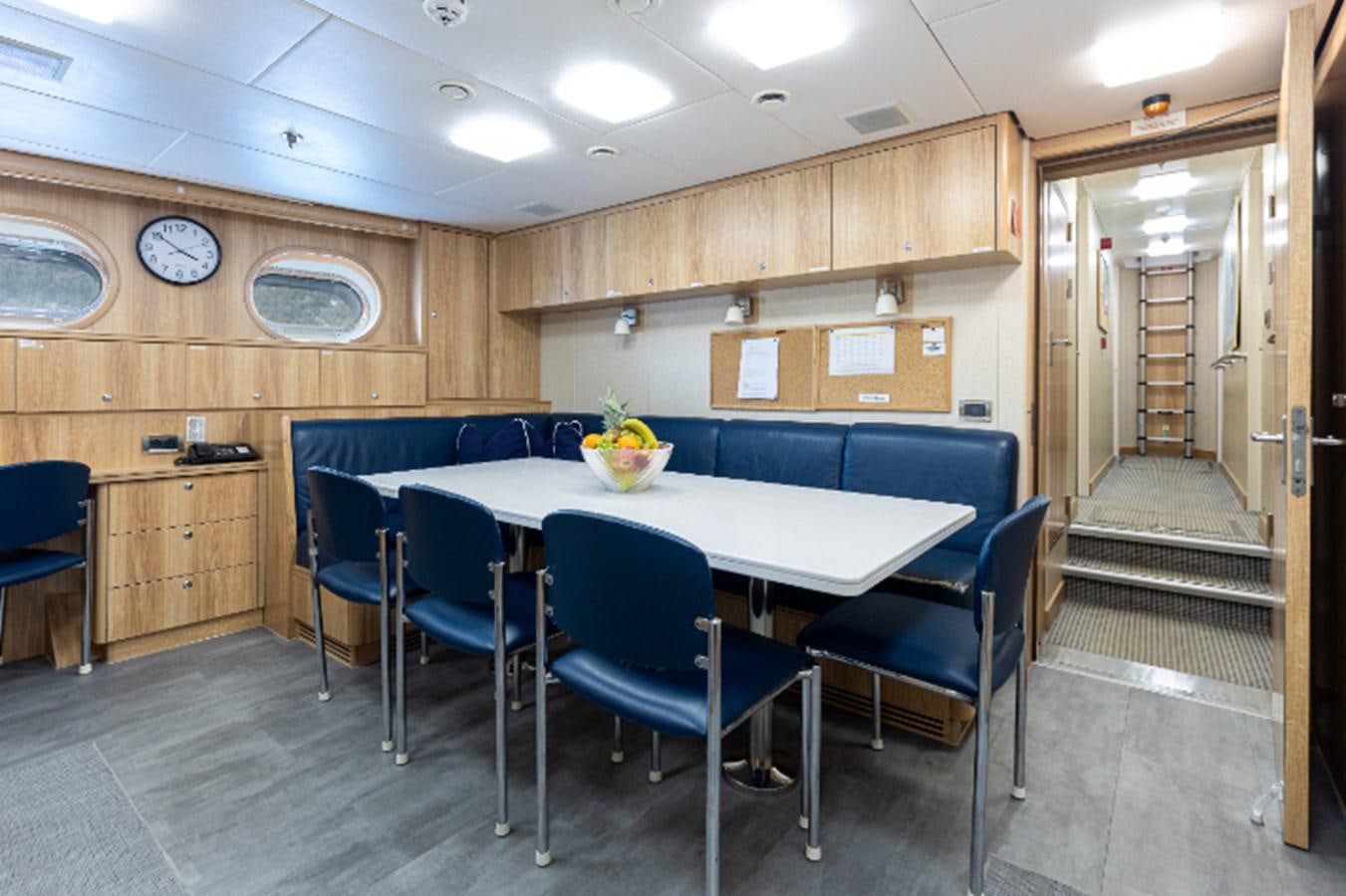 a room with a table and chairs aboard VIBRANCE Yacht for Sale