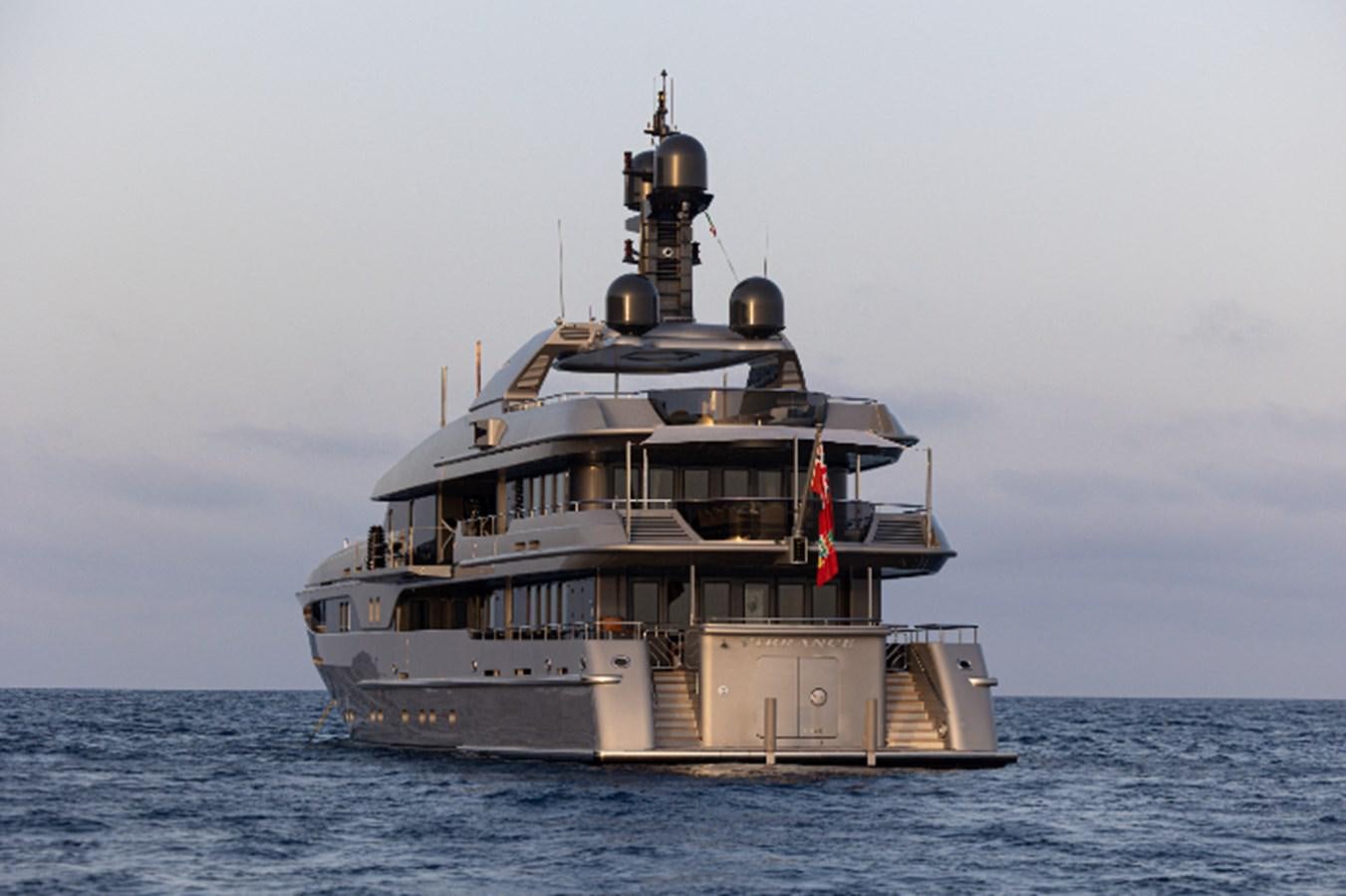 a large ship in the water with Thomas Point Shoal Light in the background aboard VIBRANCE Yacht for Sale
