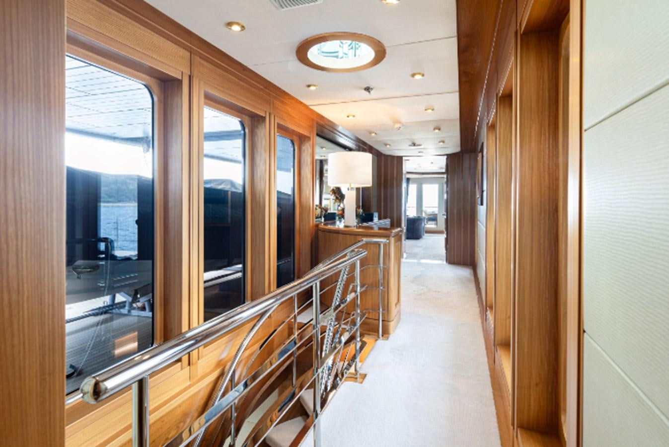 a hallway with glass doors aboard VIBRANCE Yacht for Sale