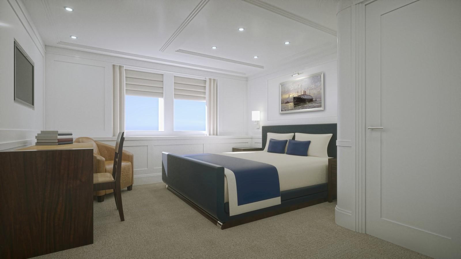 a bedroom with a bed and a desk aboard PROJECT MARLIN Yacht for Sale