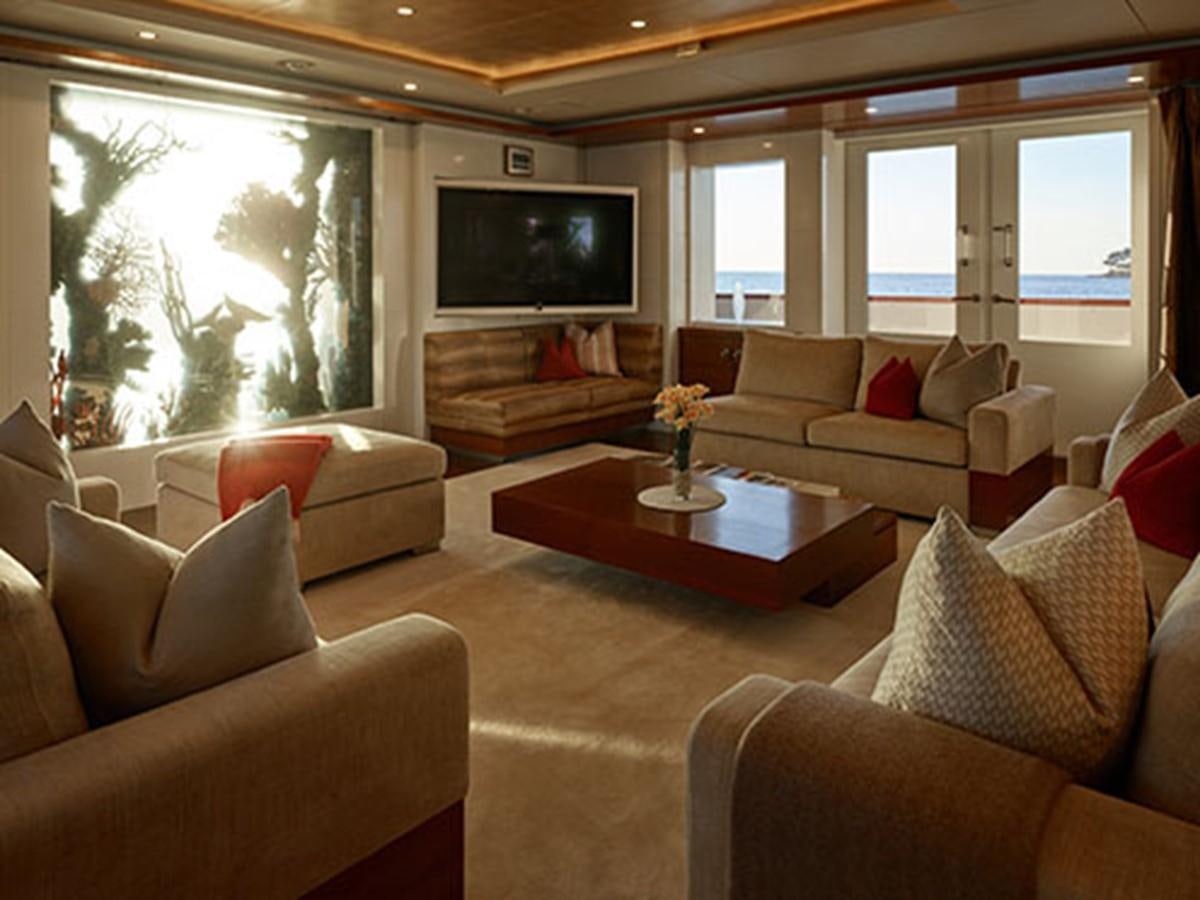 a living room with a tv and furniture aboard NASSIMA Yacht for Sale