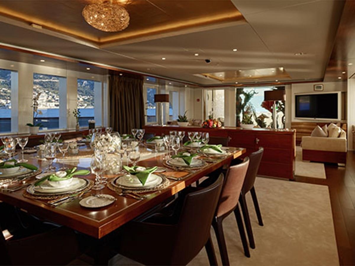 a dining room with a table set aboard NASSIMA Yacht for Sale