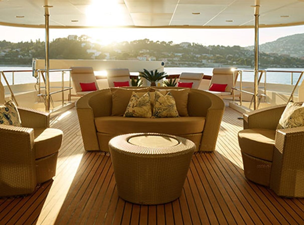 a living room with a couch and a table aboard NASSIMA Yacht for Sale