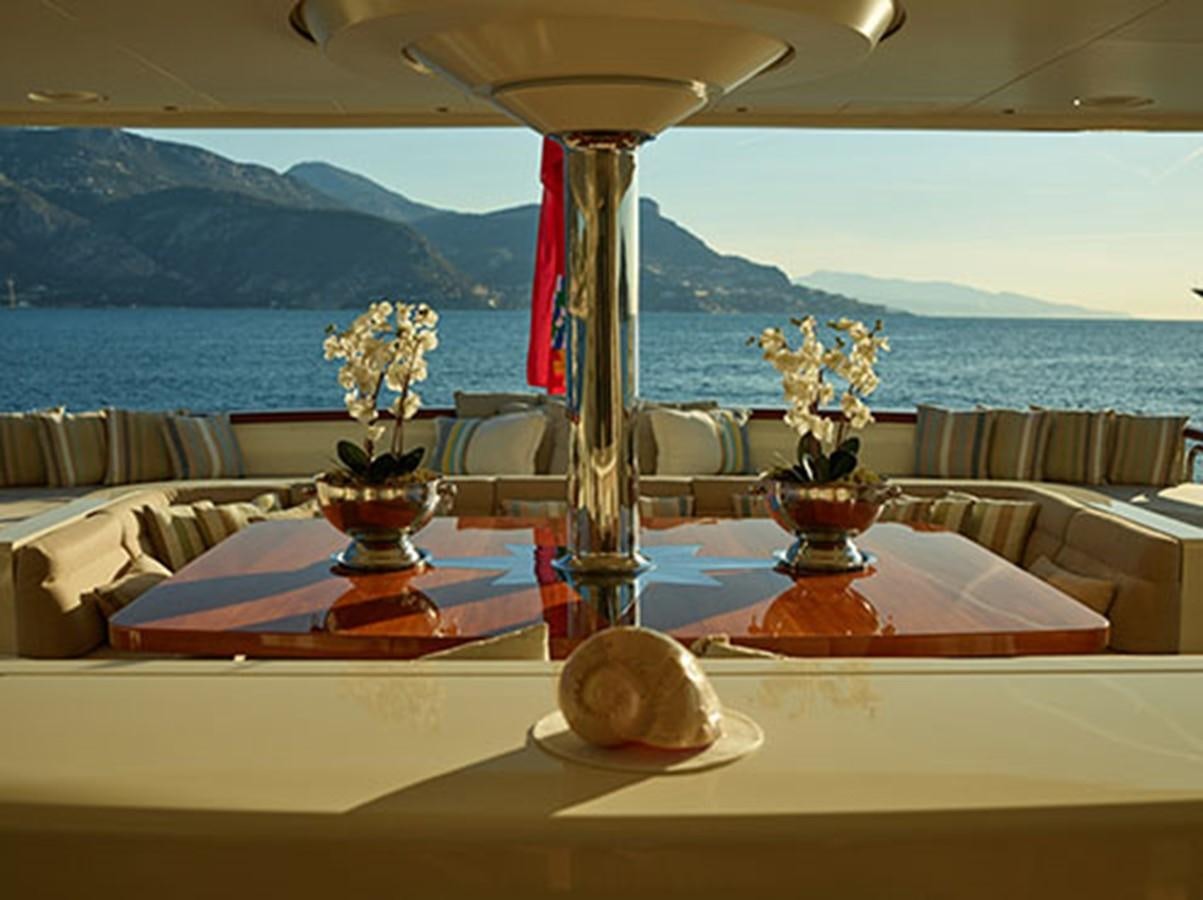 a table with a vase and a flower on it aboard NASSIMA Yacht for Sale