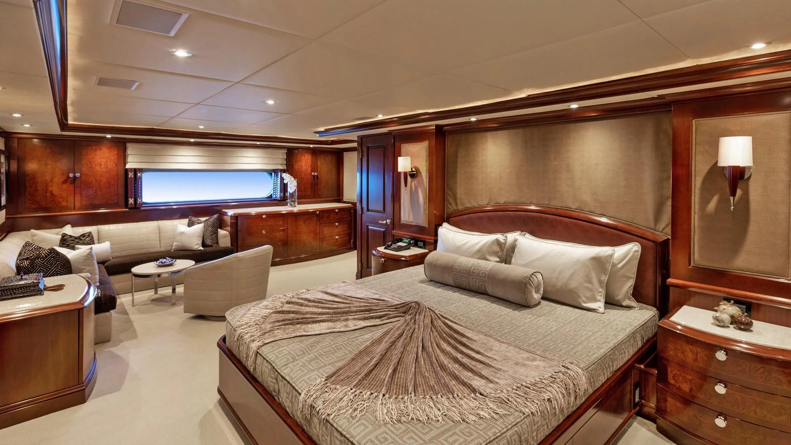 a bedroom with a bed and a couch aboard GLAZE Yacht for Sale