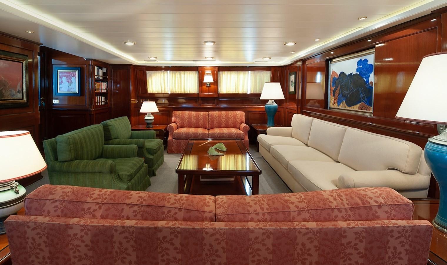 a living room with a couch and a coffee table aboard BELLE BRISE Yacht for Sale