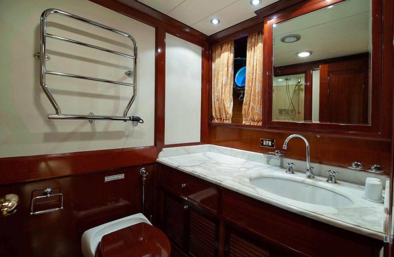 a bathroom with a sink and mirror aboard BELLE BRISE Yacht for Sale