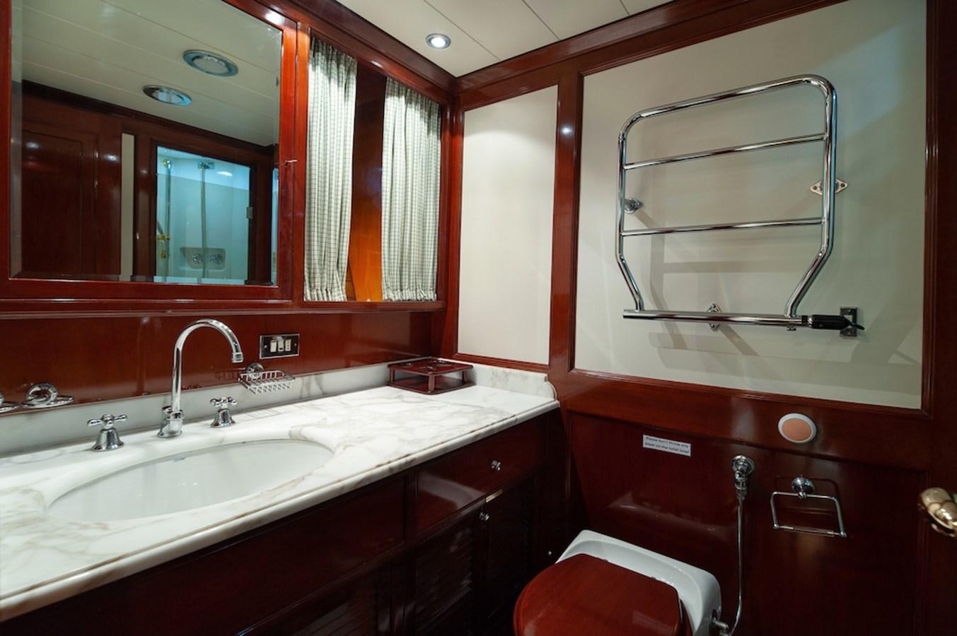 a bathroom with red cabinets aboard BELLE BRISE Yacht for Sale