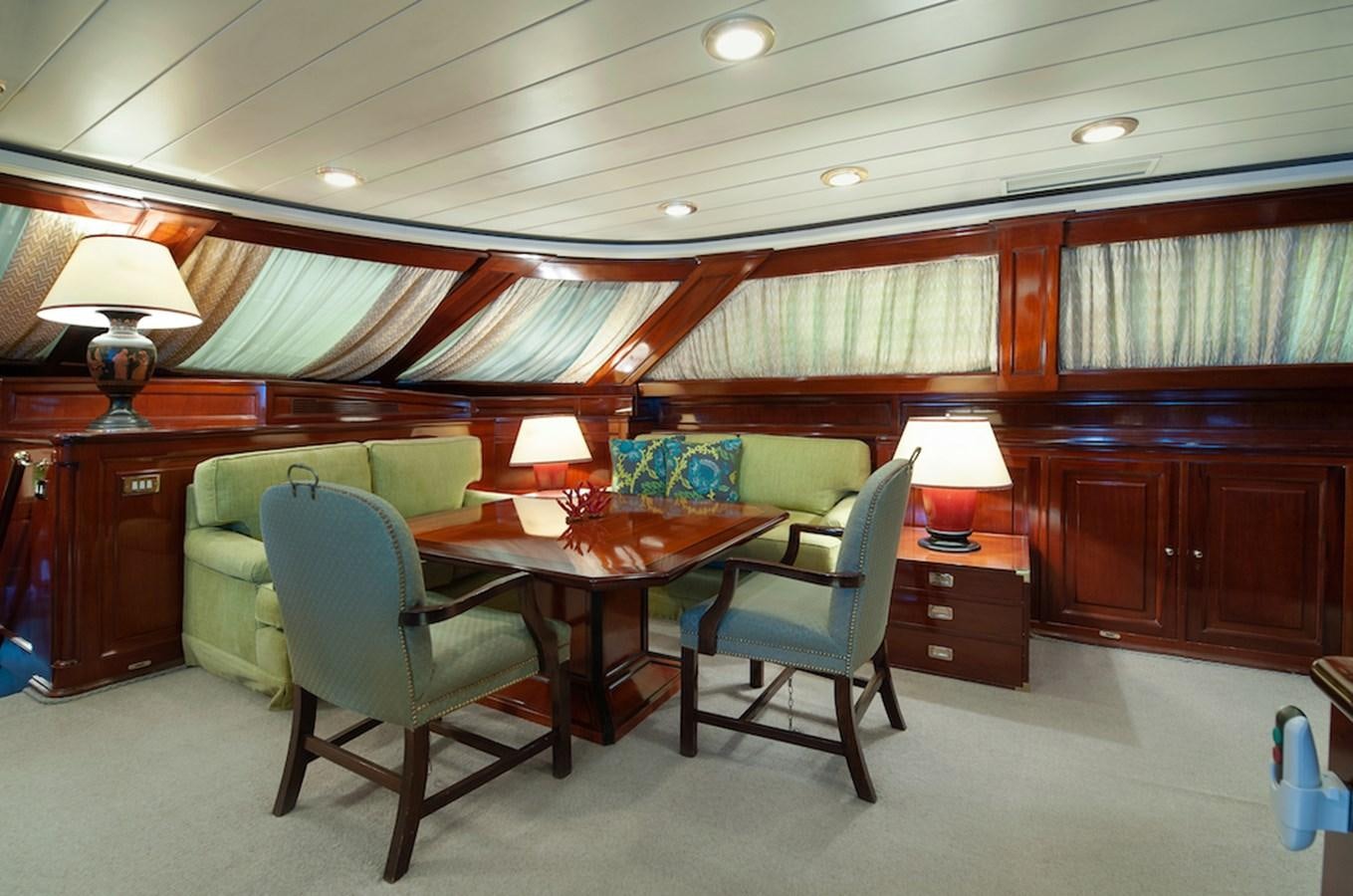 a room with a table and chairs aboard BELLE BRISE Yacht for Sale