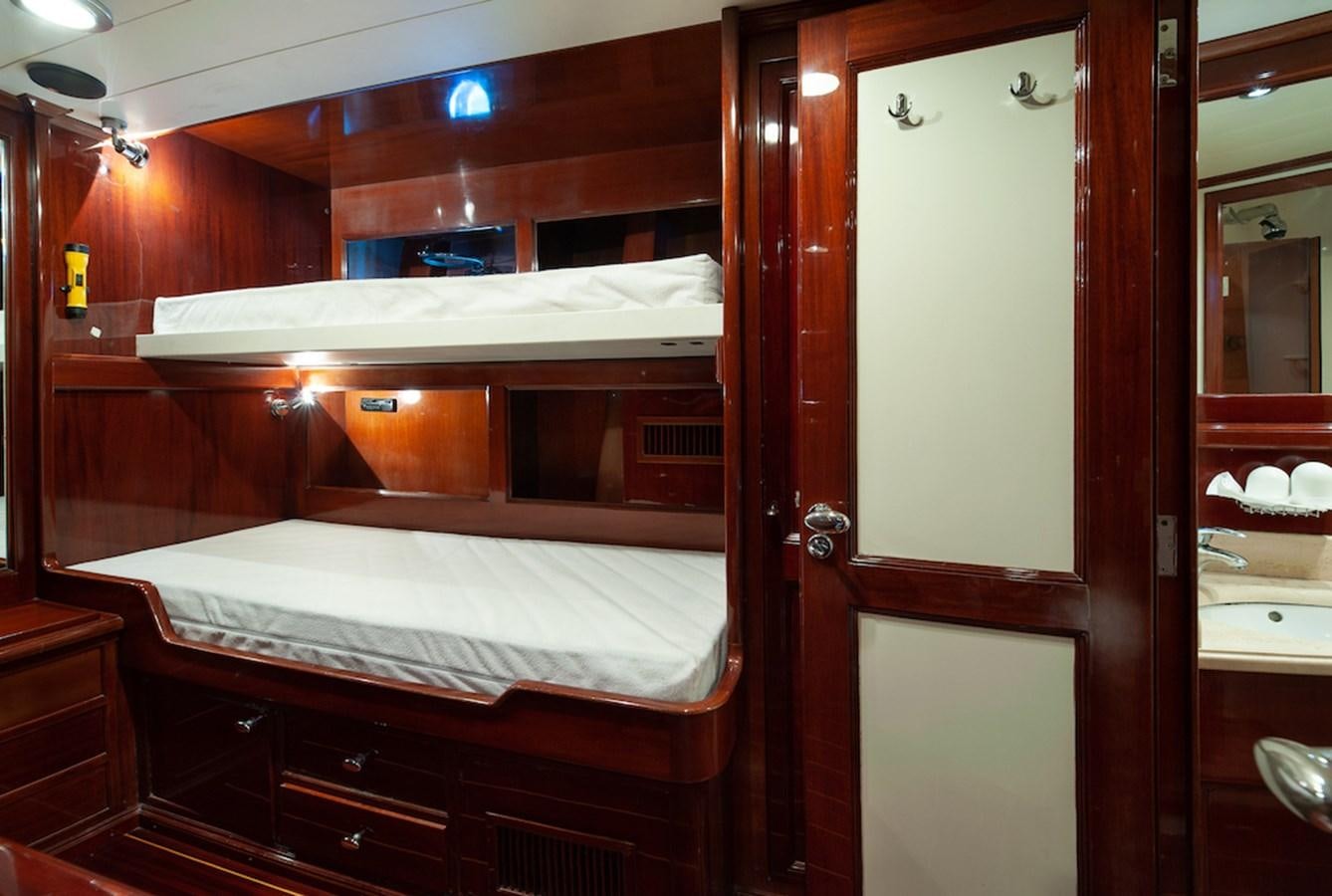 a room with a bed and a door aboard BELLE BRISE Yacht for Sale