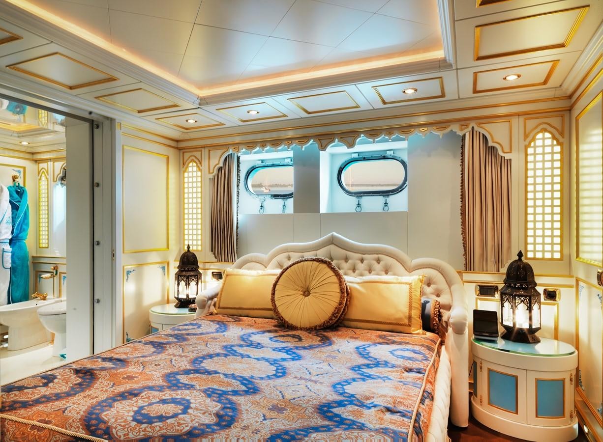 a bedroom with a bed and a mirror aboard AQUAMARINA Yacht for Sale