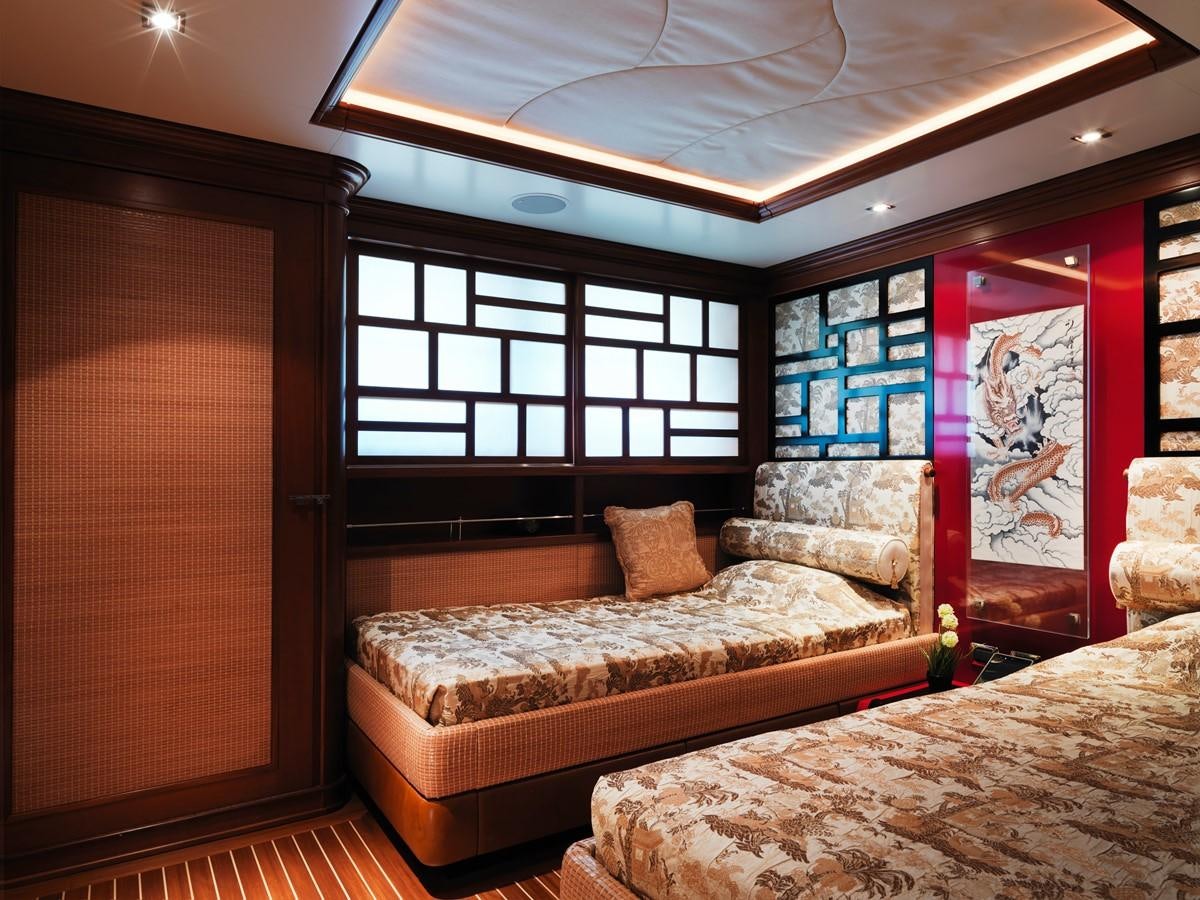 a bedroom with a bed and a window aboard AQUAMARINA Yacht for Sale
