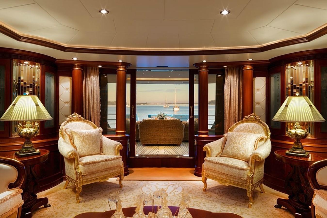 a room with a couple of chairs and a table with lamps aboard AQUAMARINA Yacht for Sale