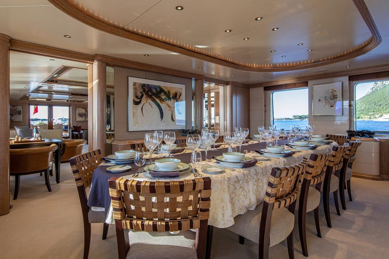 a large dining room with tables and chairs aboard VA BENE Yacht for Sale