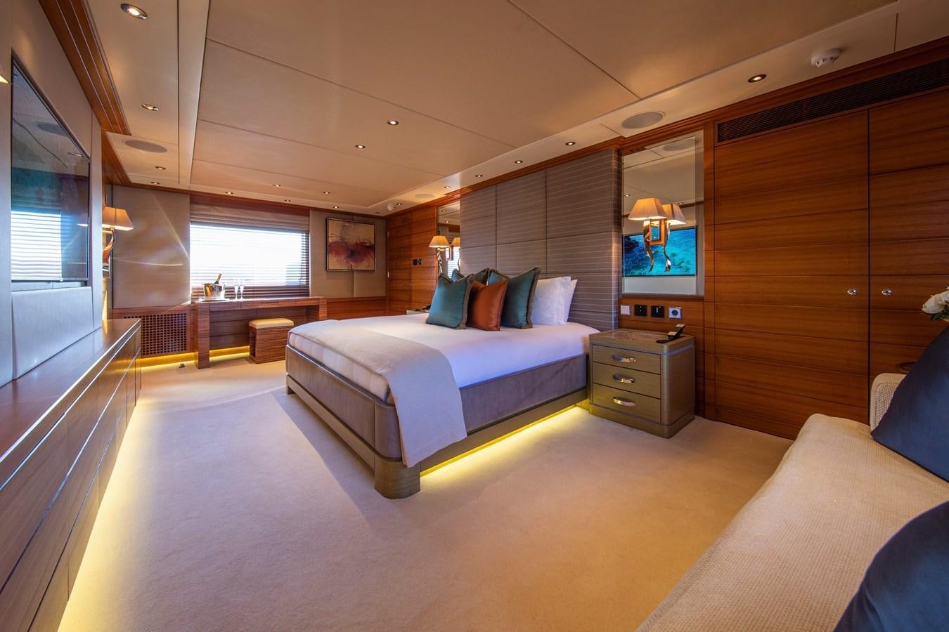 a bedroom with a bed and a television aboard VA BENE Yacht for Sale