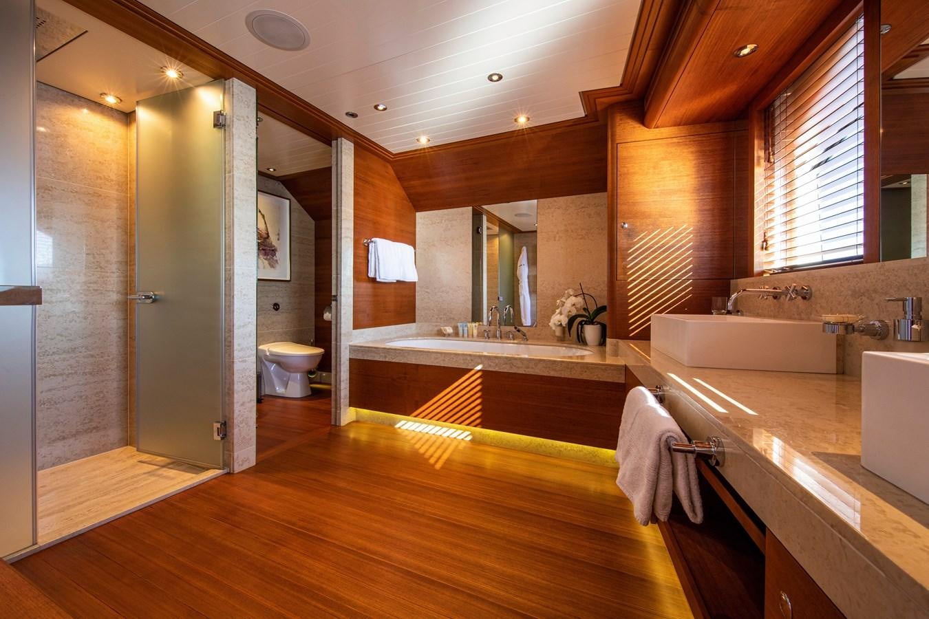 a bathroom with a tub and a sink aboard VA BENE Yacht for Sale