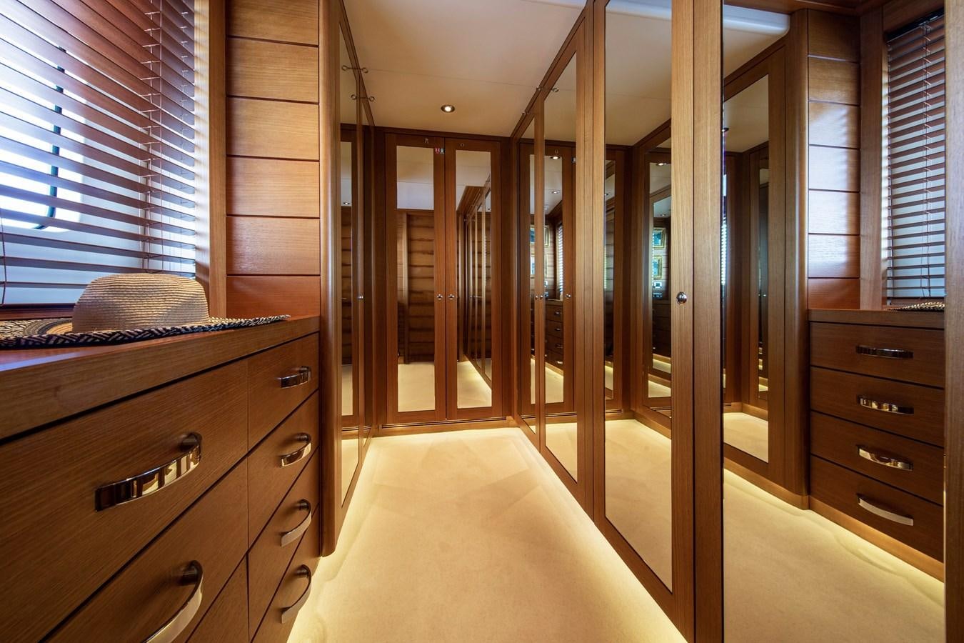 a room with a bed and a dresser aboard VA BENE Yacht for Sale