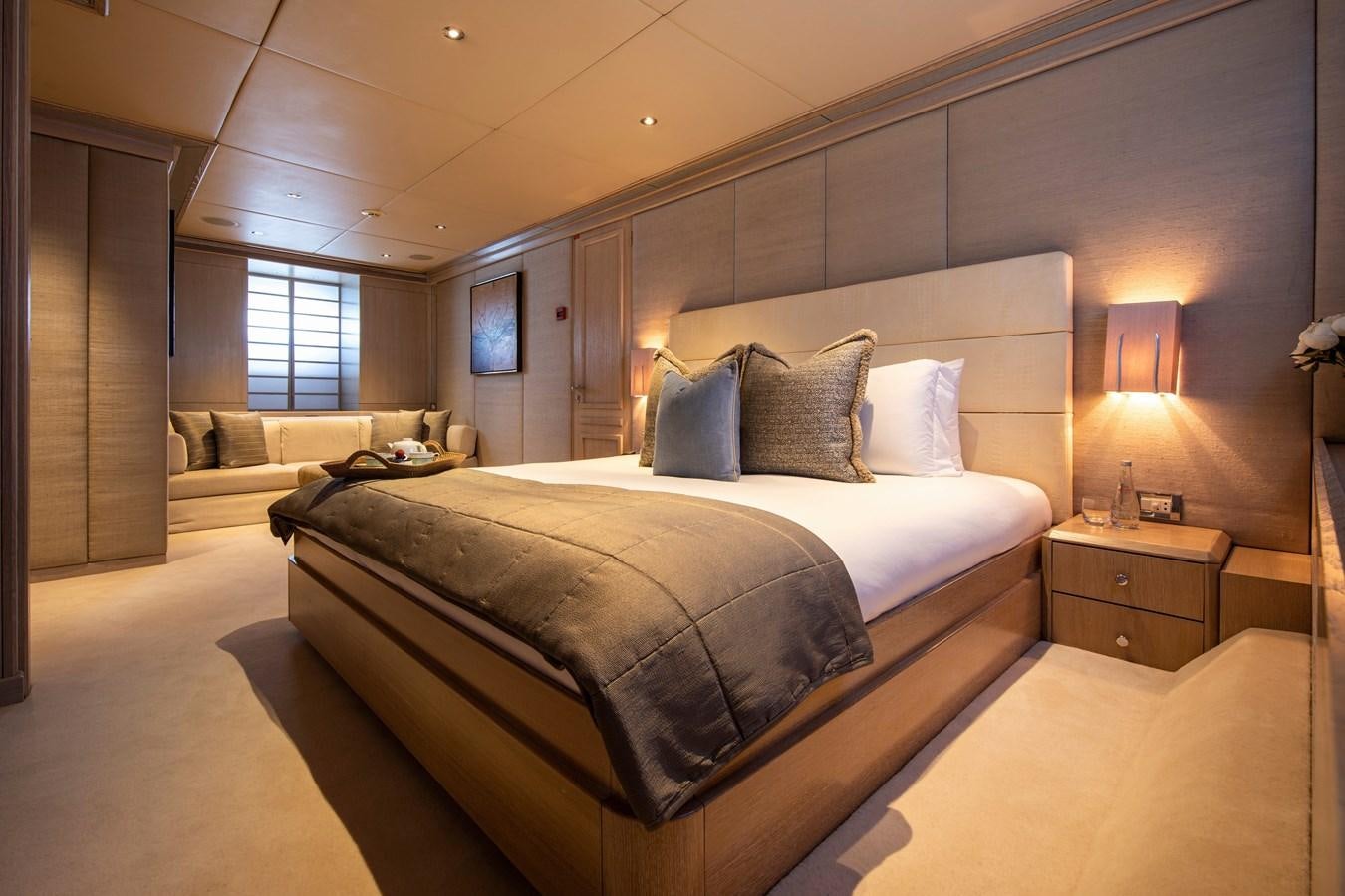 a room with a bed and a couch aboard VA BENE Yacht for Sale