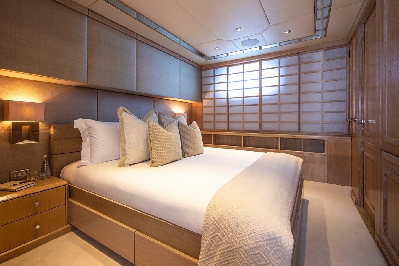 a room with a bed and a window aboard VA BENE Yacht for Sale